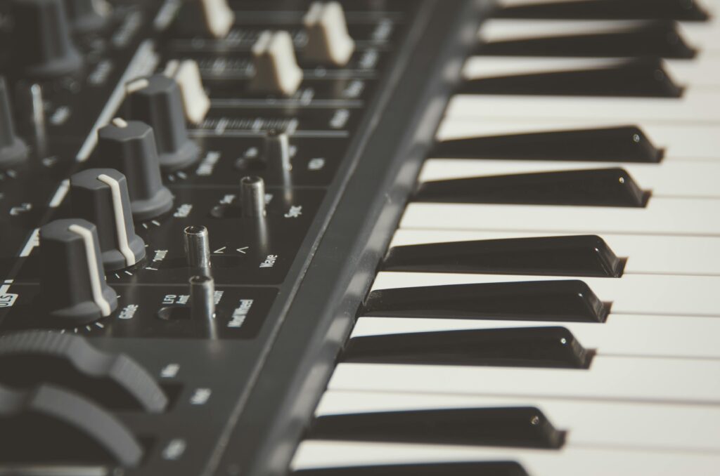 Detailed view of an electronic keyboard and its control knobs, highlighting modern musical equipment.